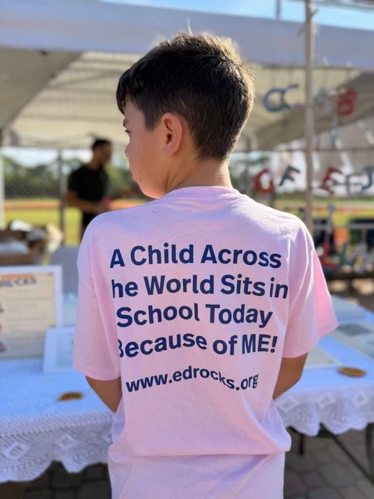 GROW student wearing Education Rocks shirt at fundraising event