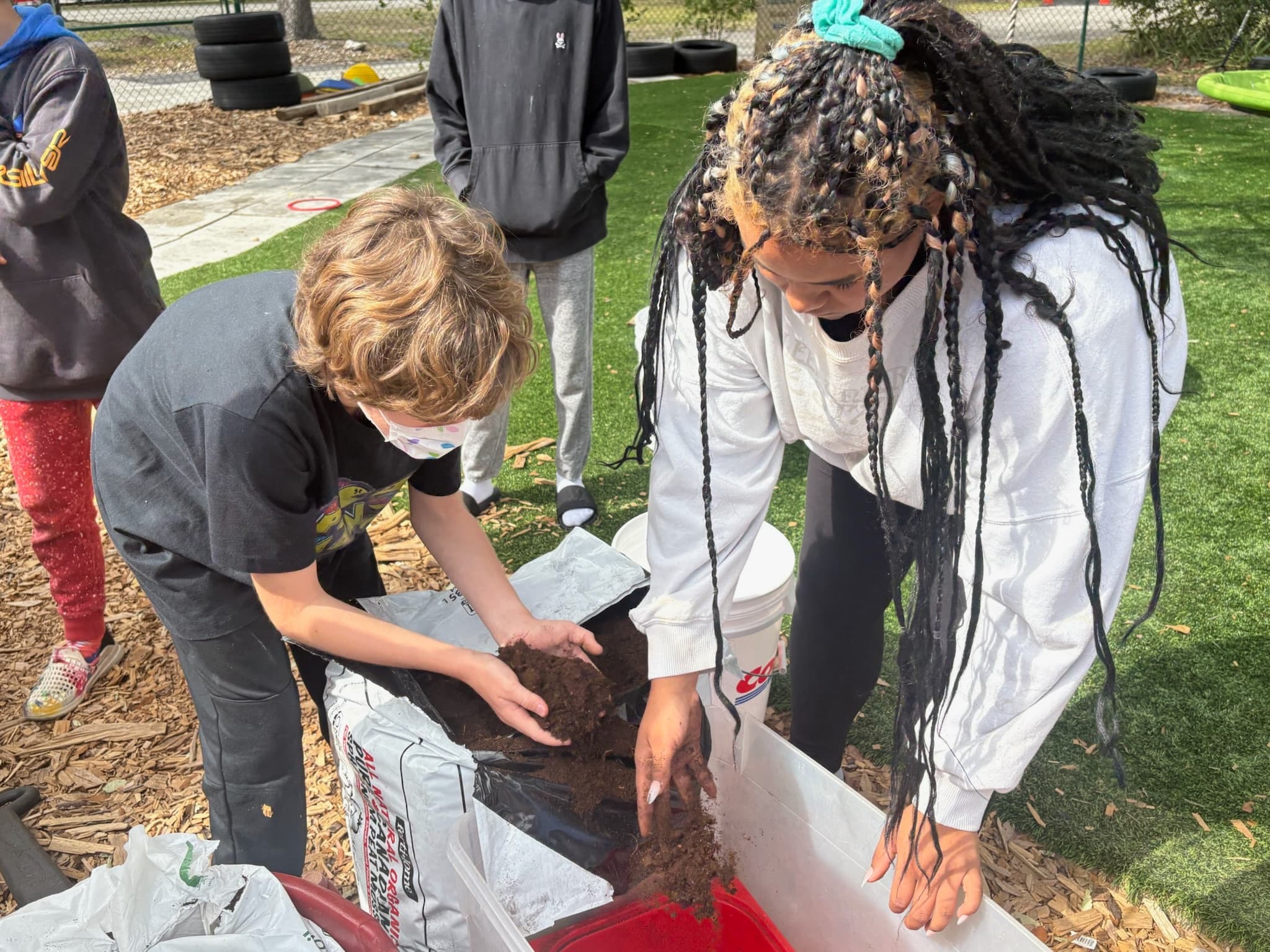 Students working with soil and compost